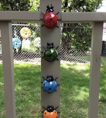 The same lady bug sculptures lined up on a porch balcony
