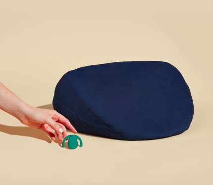 the same vibrator in green with a wedge shape pillow