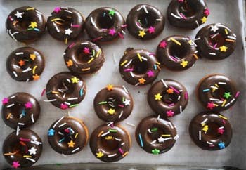 Reviewer photo a finished tray of donuts with chocolate frosting and rainbow sprinkles