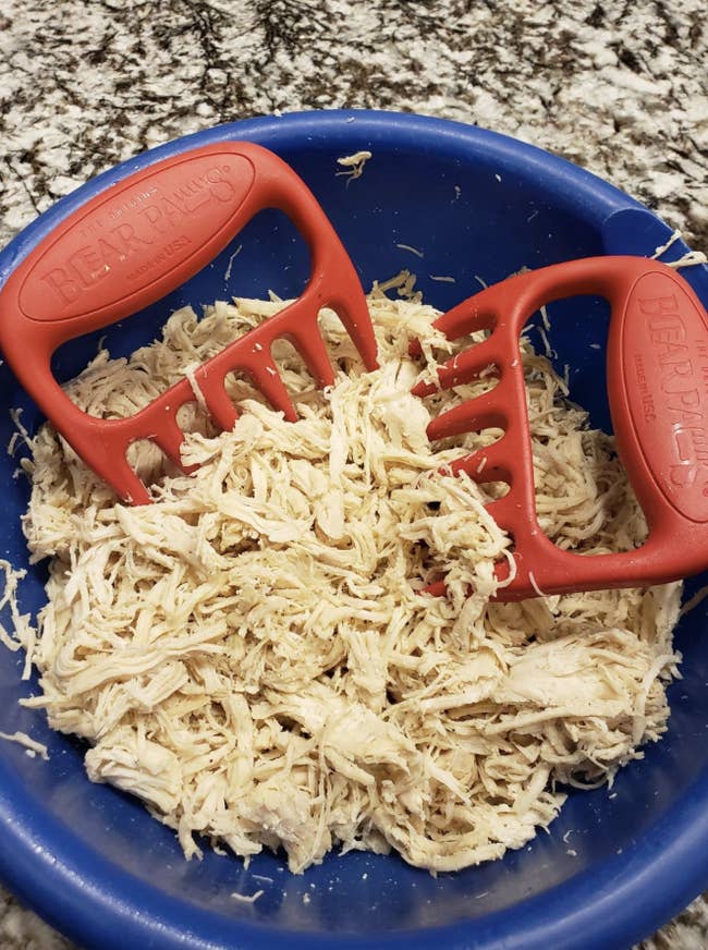 The claws resting on a bowl of shredded chicken
