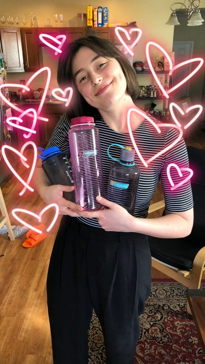 Reviewer holding three Nalgenes, illustrated with hearts