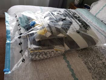 Reviewer's before photo of a bag with a comforter and pillows inside it