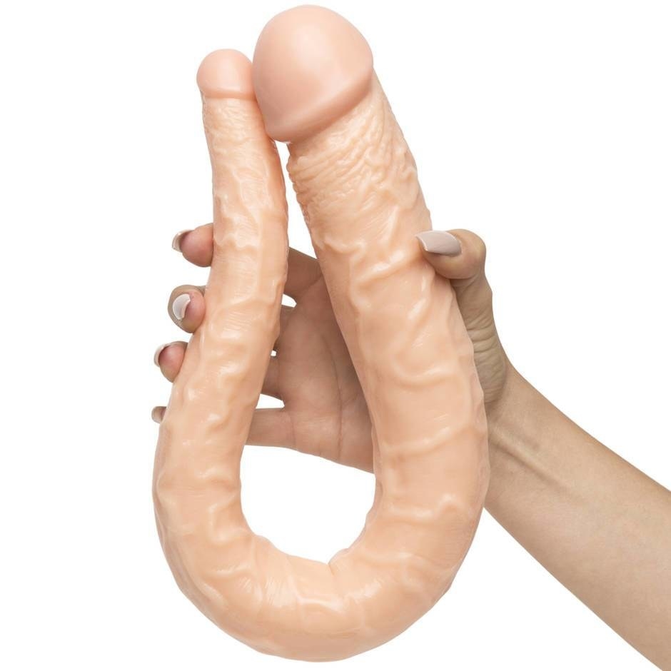model&#x27;s hand holding the long realistic looking dildo with it bent in half in one hand to show its flexibility