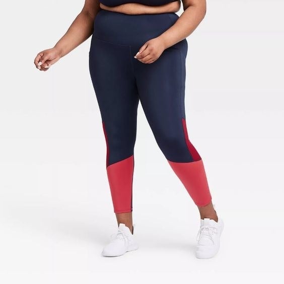 Model wearing the navy blue and pink leggings