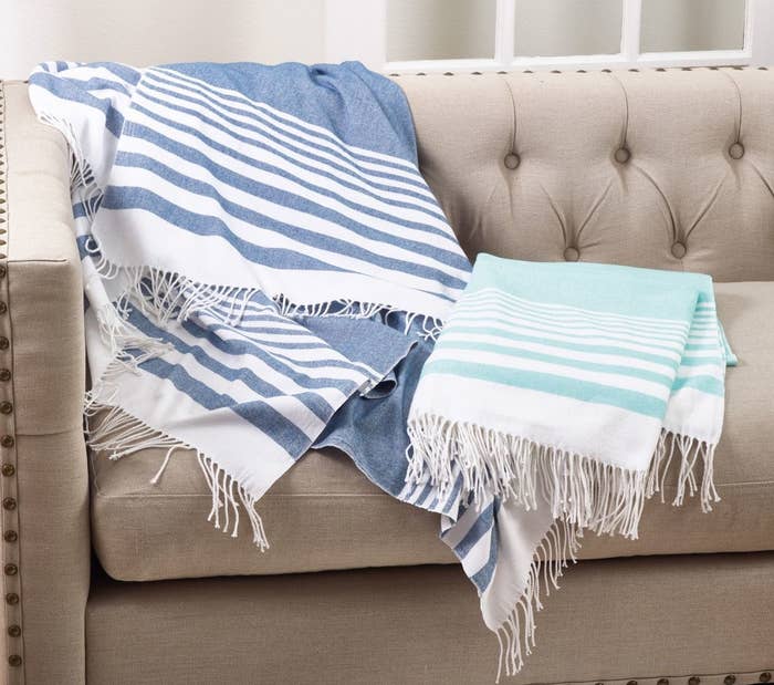 the striped blue and white blanket with tassel trim 