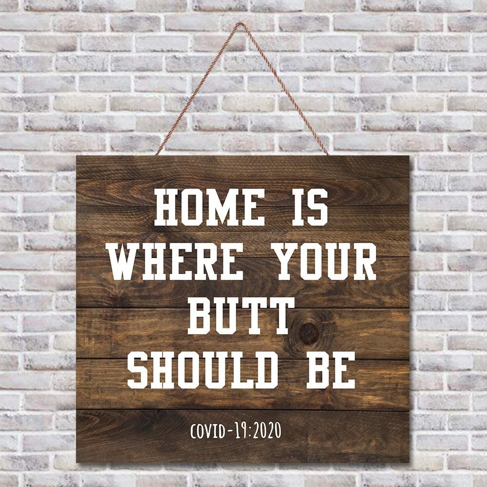A wooden sign that says &quot;Home is where your butt should be - Covid-19 : 2020&quot;