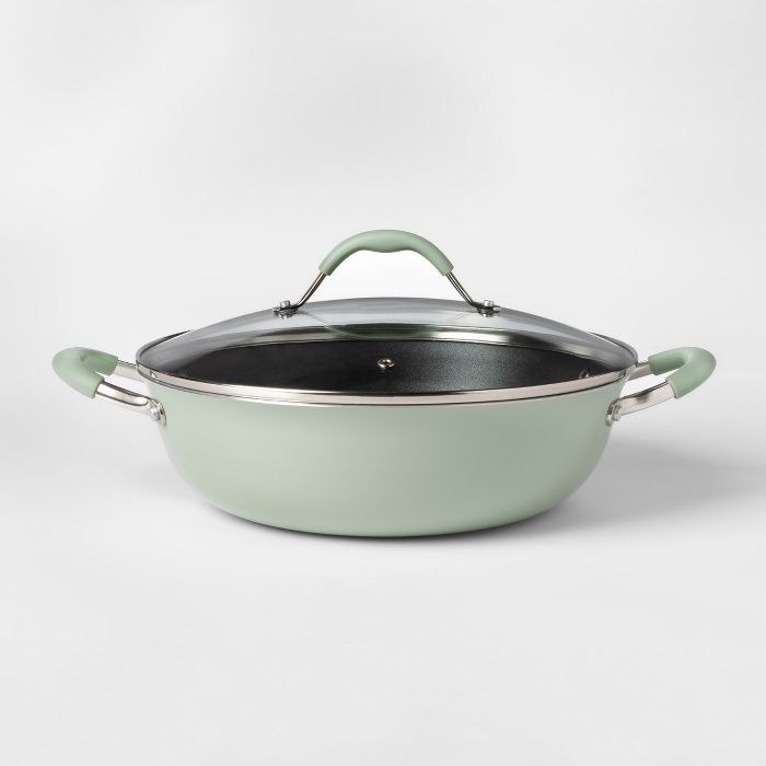 a light green pan with a handles on each side and a lid with a matching handle