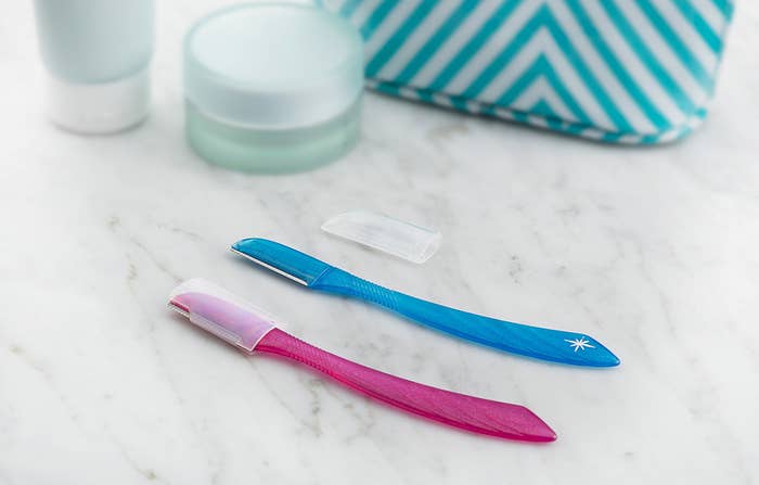 Two touch up razors on a counter