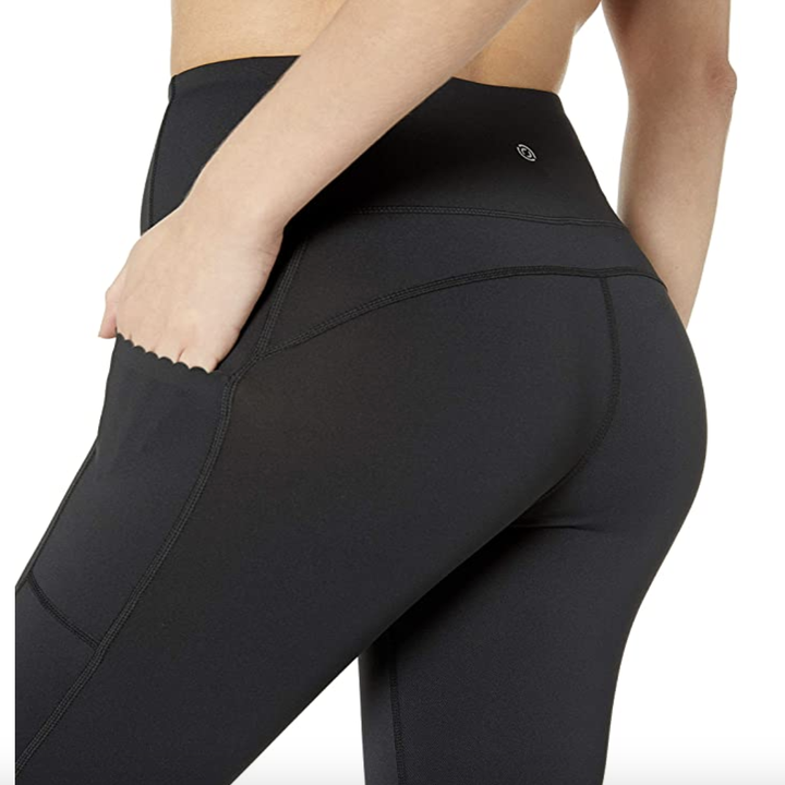 The backside of the leggings showing the scalopped edge of the side pockets 