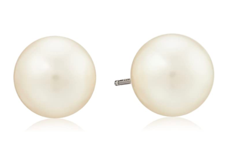 A pair of large round pearl earrings are on a plain background