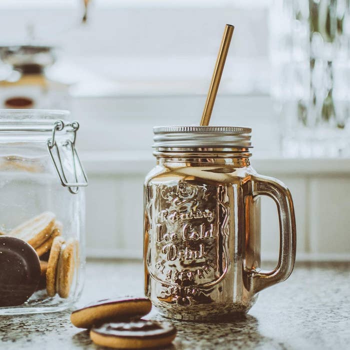 Gold mason jar with a lid with a reusable gold metal straw 