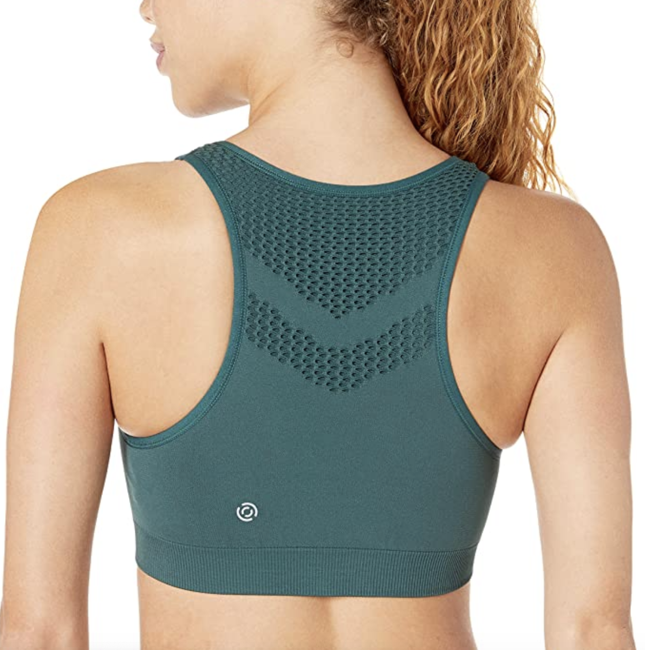 A model showing the back of a green racerback bra 