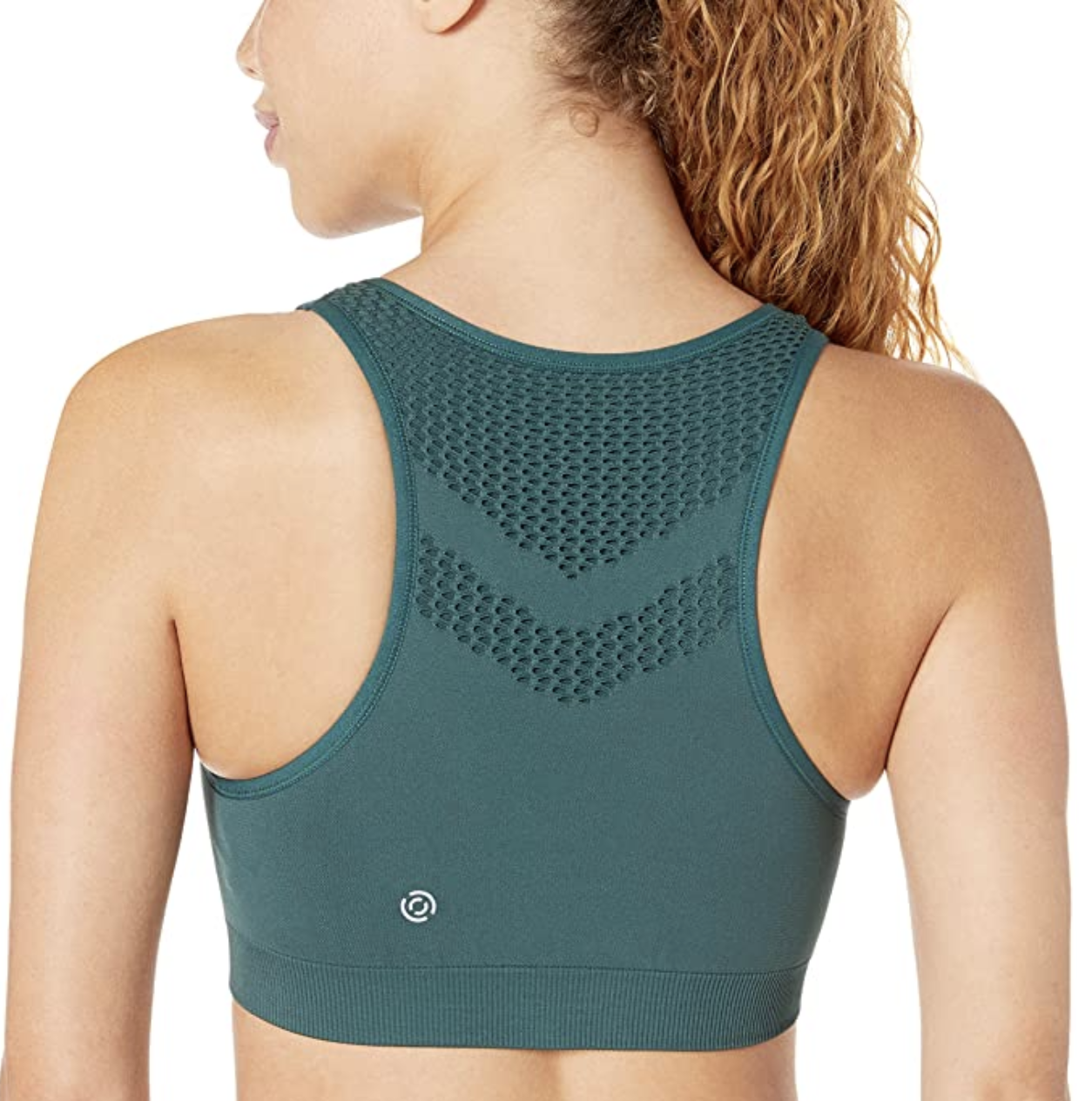 A model showing the back of a green racerback bra
