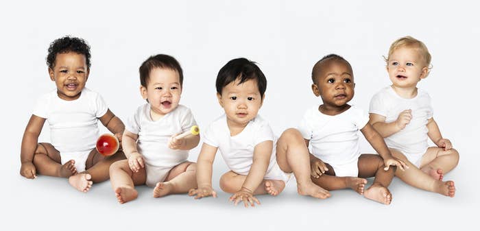 A diverse group of five babies