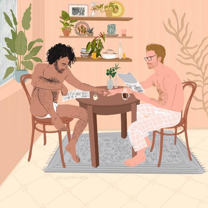A couple wearing boxers and pajama pants, holding hands across a breakfast table while reading papers and drinking coffee 