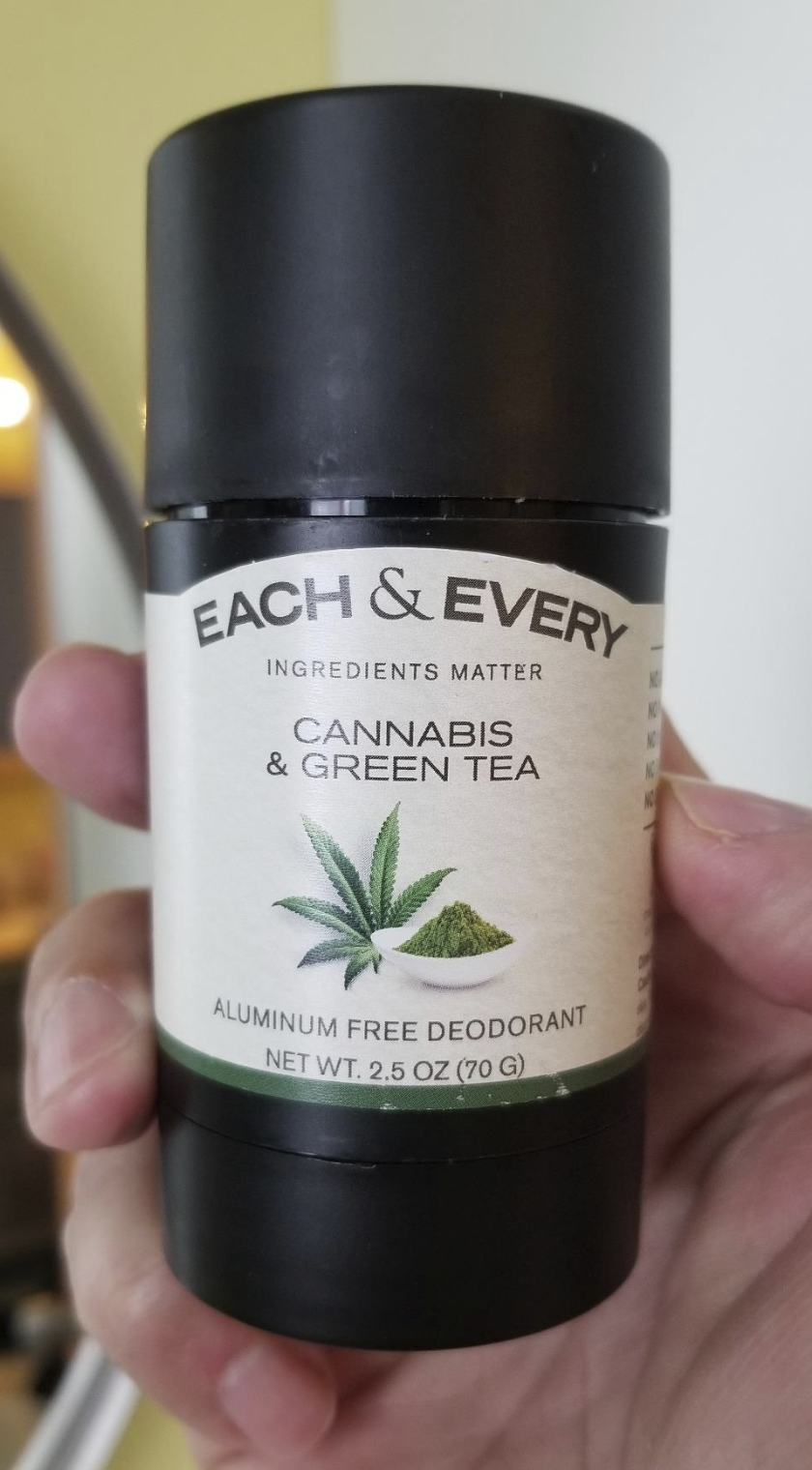 Reviewer&#x27;s hand holding the Cannabis and Green Tea scent of the deodorant