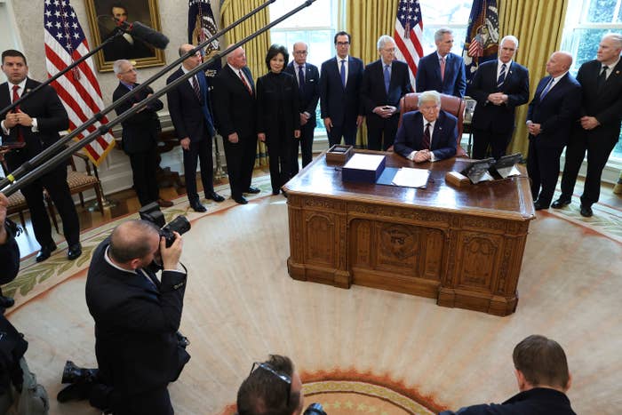 President Donald Trump signs the CARES Act on March 27, 2020, at the White House.
