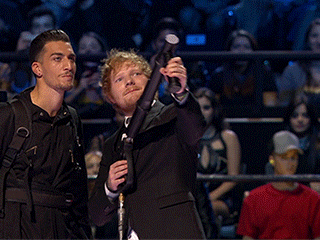 Ed Sheeran shoots a confettis canon during an awards show