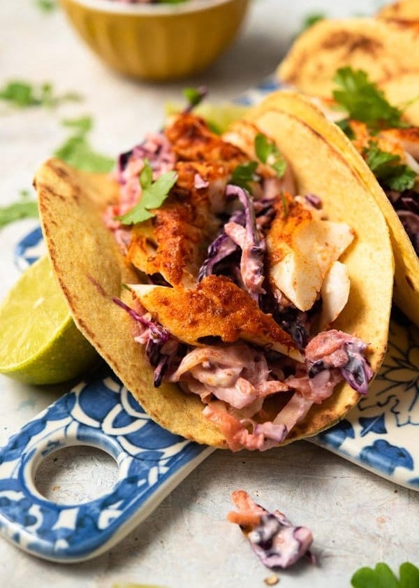 Tacos filled with crispy white fish and creamy cabbage slaw with fresh herbs.