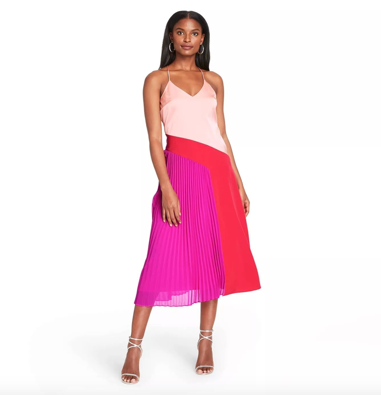Model wearing the pink and red pleated dress