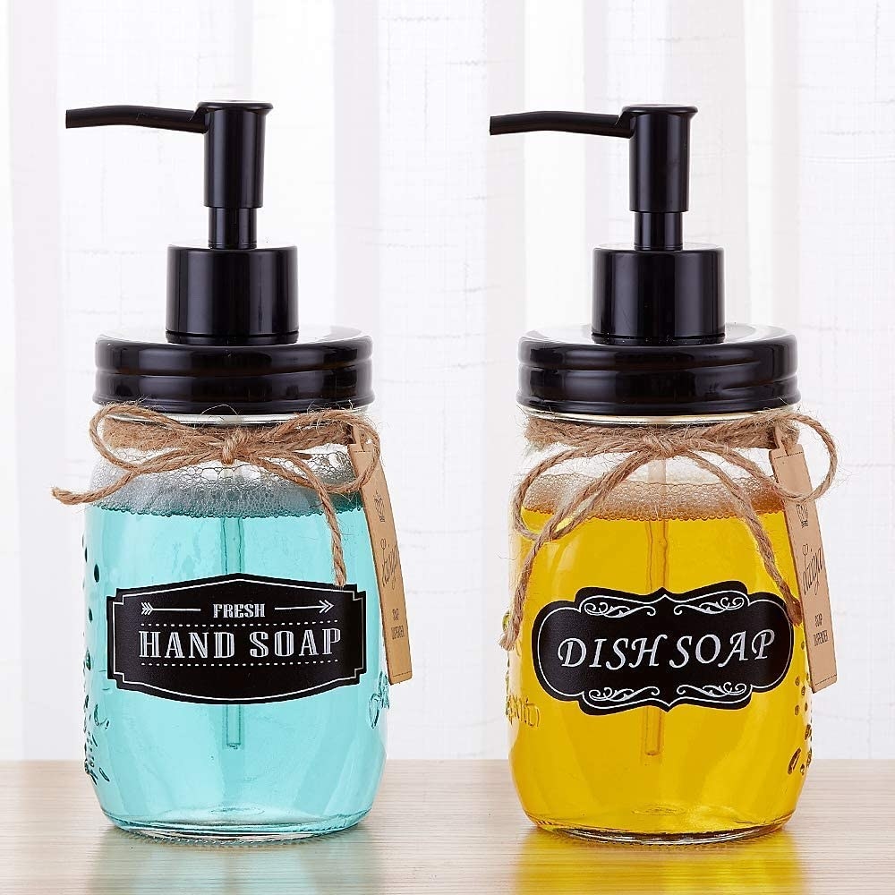 two clear glass mason jars with black pump and chalkboard labels 