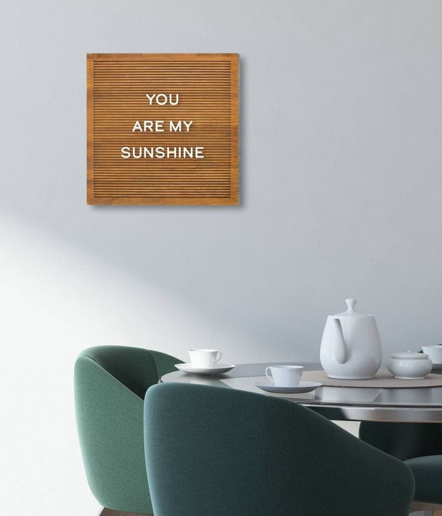brown board with white letters spelling "you are my sunshine"