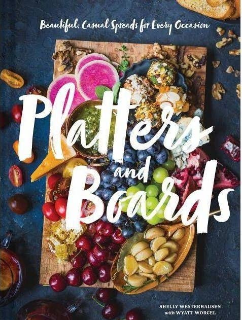 The cover of a book with a charcuterie board