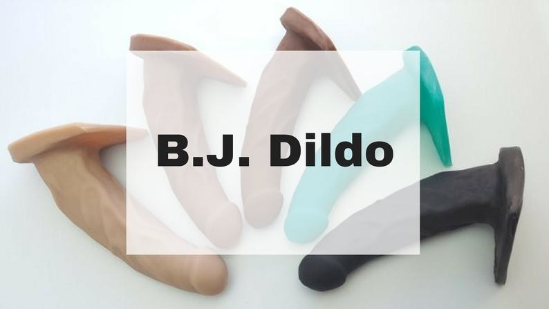 five different colors of realistic looking dildos with a flared base