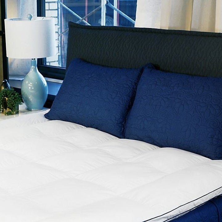 The topper on a bed