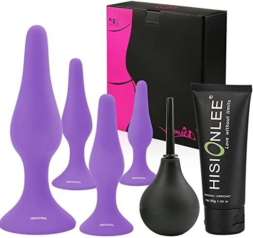 product shot of four purple anal plugs, douche, and lube