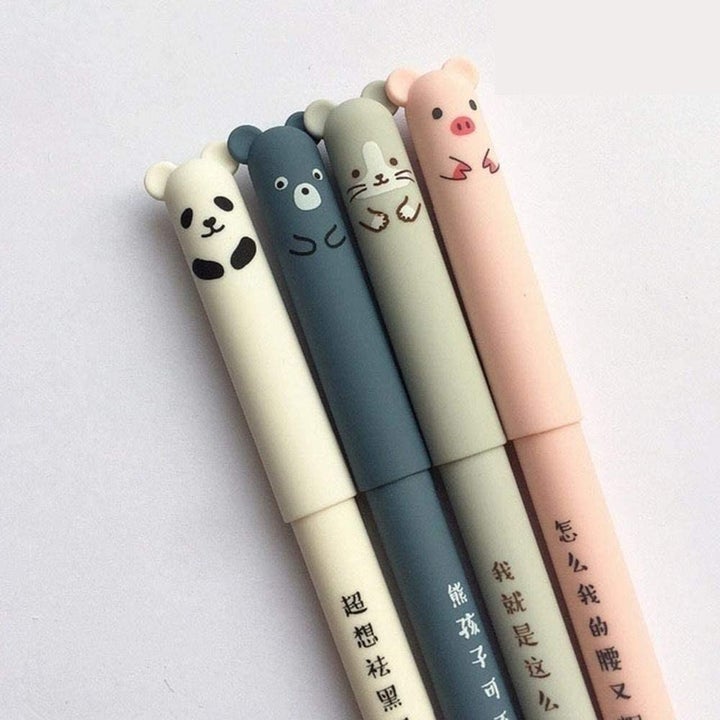 Four pens with little animal faces on the tips of the lids