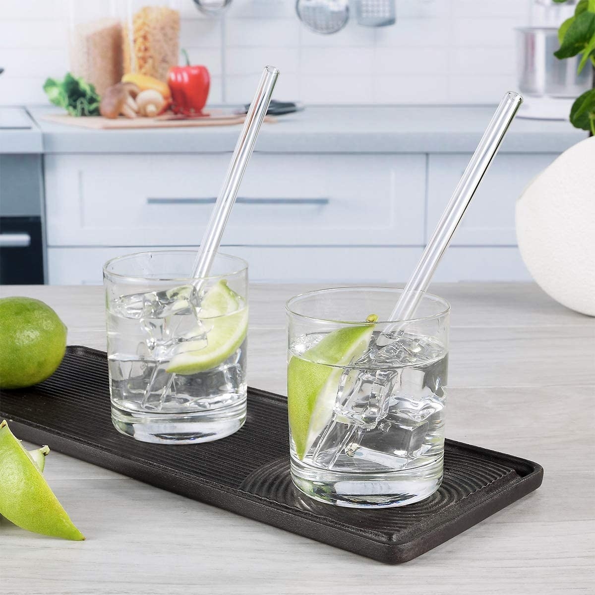 Two glasses with straight glass straws 