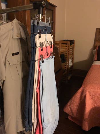 Reviewer photo of one of the hangers with four skirts hanging on it and taking up the same amount of space as one hanger