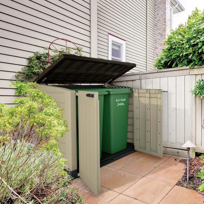 The storage shed opened up to reveal garbage bins