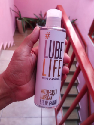 hand holding the bottle of lube