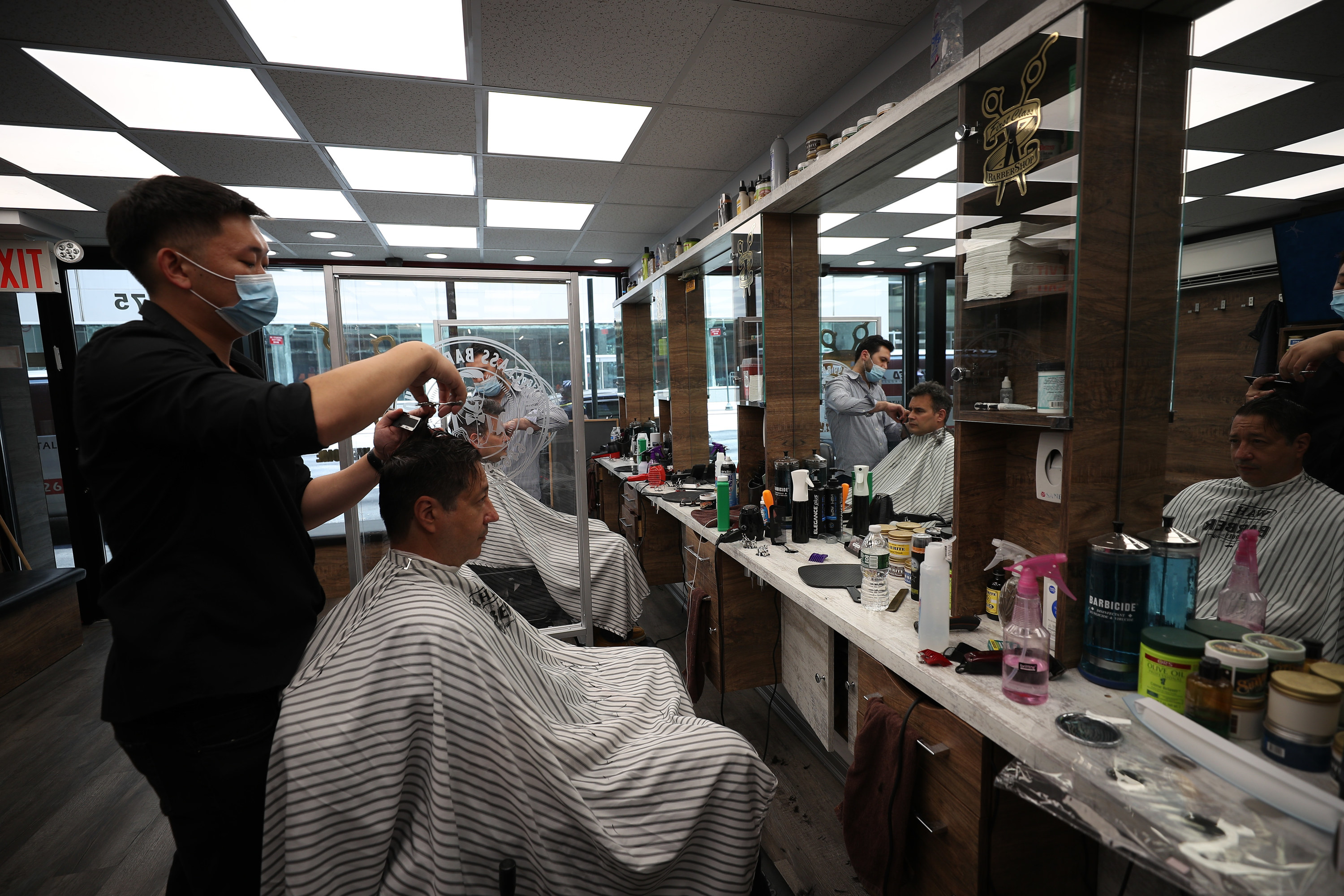 Barber cuts customer&#x27;s hair