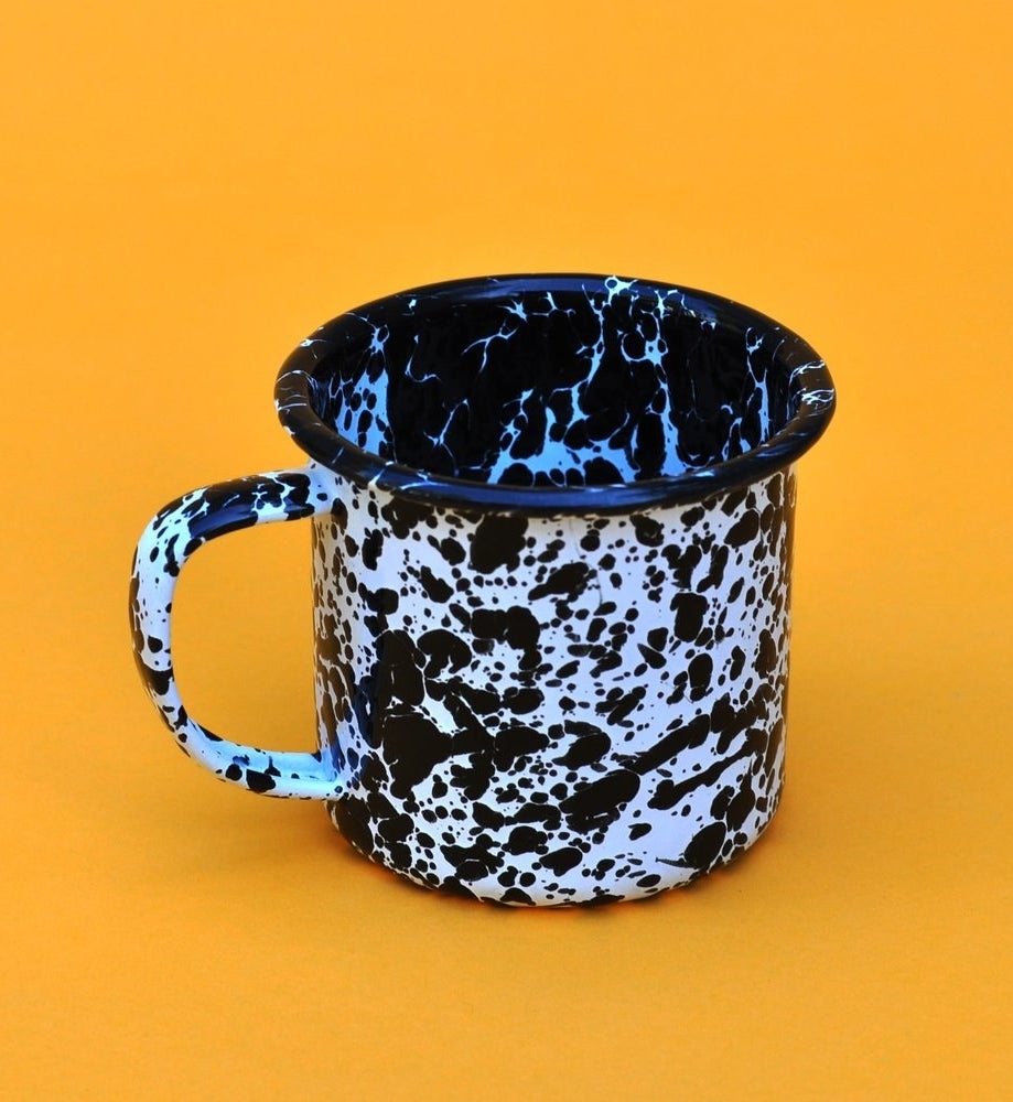 The mug with a lip on the top and black and white speckles