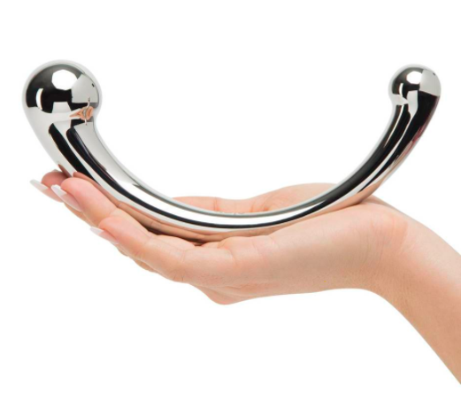 model holding a curved stainless steel dildo with two different size heads