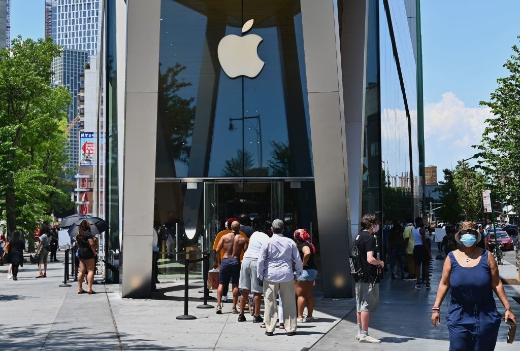 People wait in line outside an Apple store