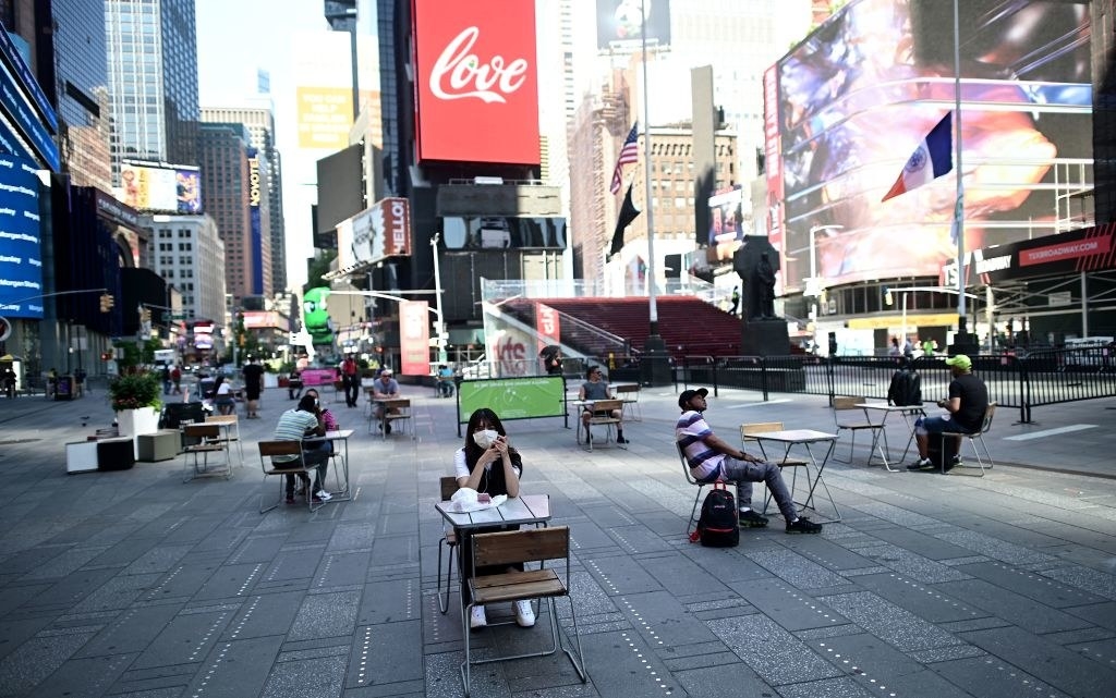 People sit at tables in Times Square