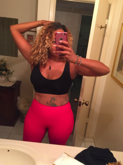 Reviewer wears black seamless sports bra with hot pink workout leggings
