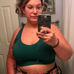 Reviewer wears same bra in a dark green color while talking a selfie