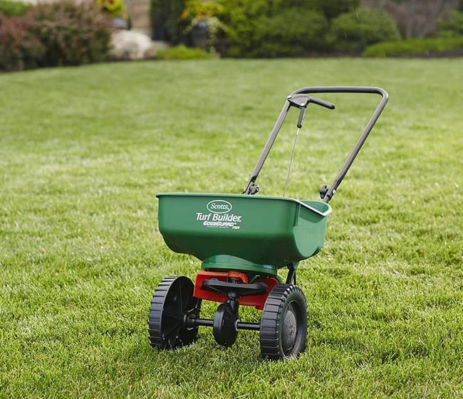 The turf spreader that looks like a small cart 