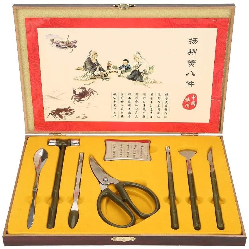 An open set of tools containing claws, a hammer, and extraction tools for seafood
