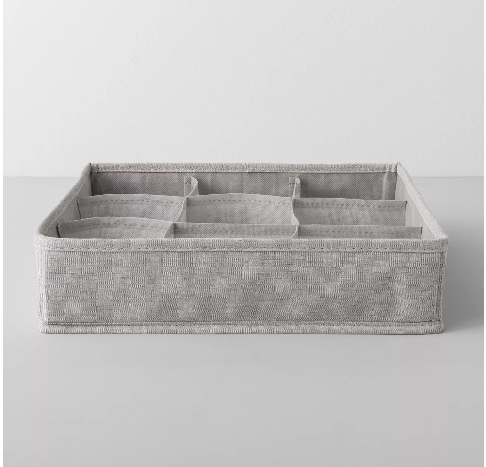 a grey organizer with various open sections