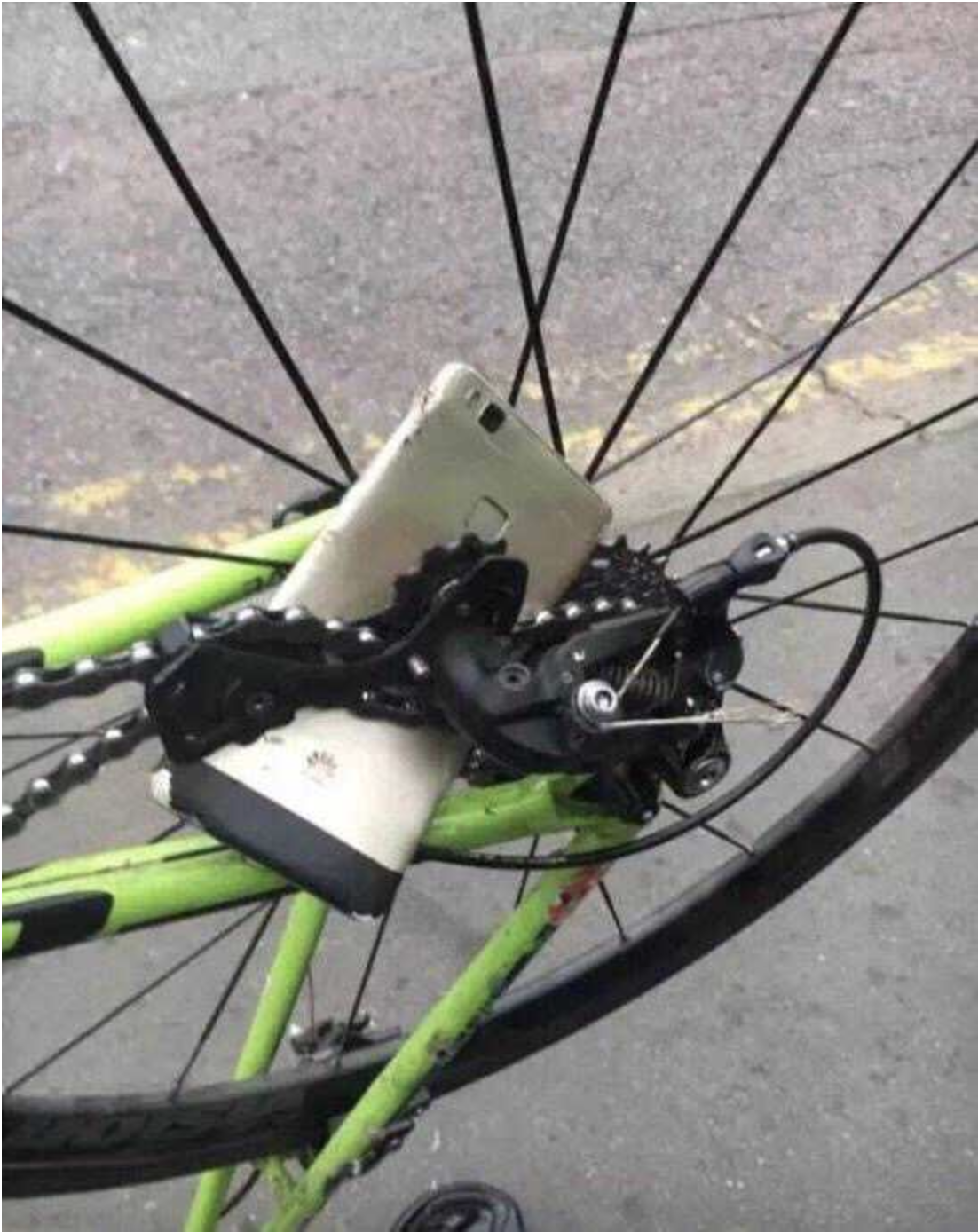 A mangled phone is tangled in a bike&#x27;s chains