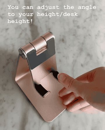 gif of rose gold stand being adjusted labeled &quot;you can adjust the angle to your height/desk&quot; 