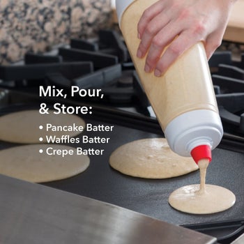 Someone pouring out batter from the Whiskware Pancake Batter Mixer with BlenderBall Wire Whisk
