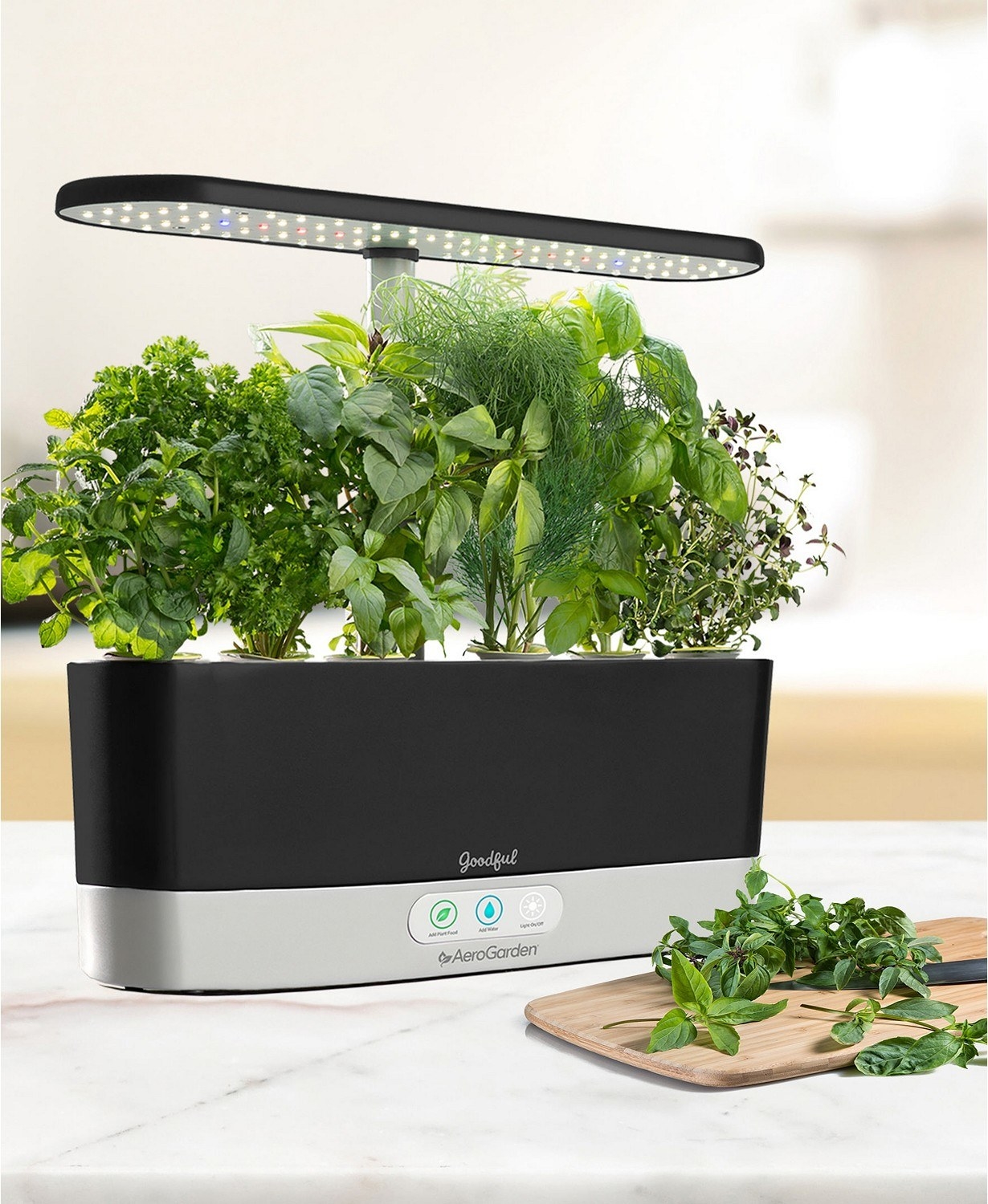 The Aerogarden harvest is about a foot long and about 2 inches wide. It has 3 buttons and green leaves sprouting from the top with an LED lamp sticking up from the bottom and towering over the leaves.
