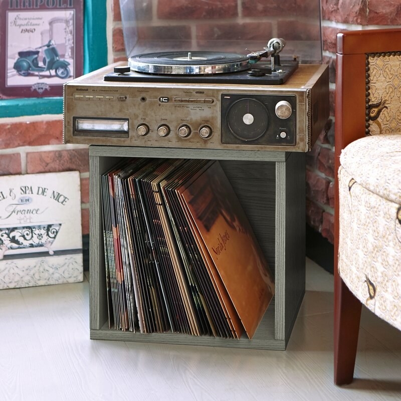 the gray storage cube with records inside